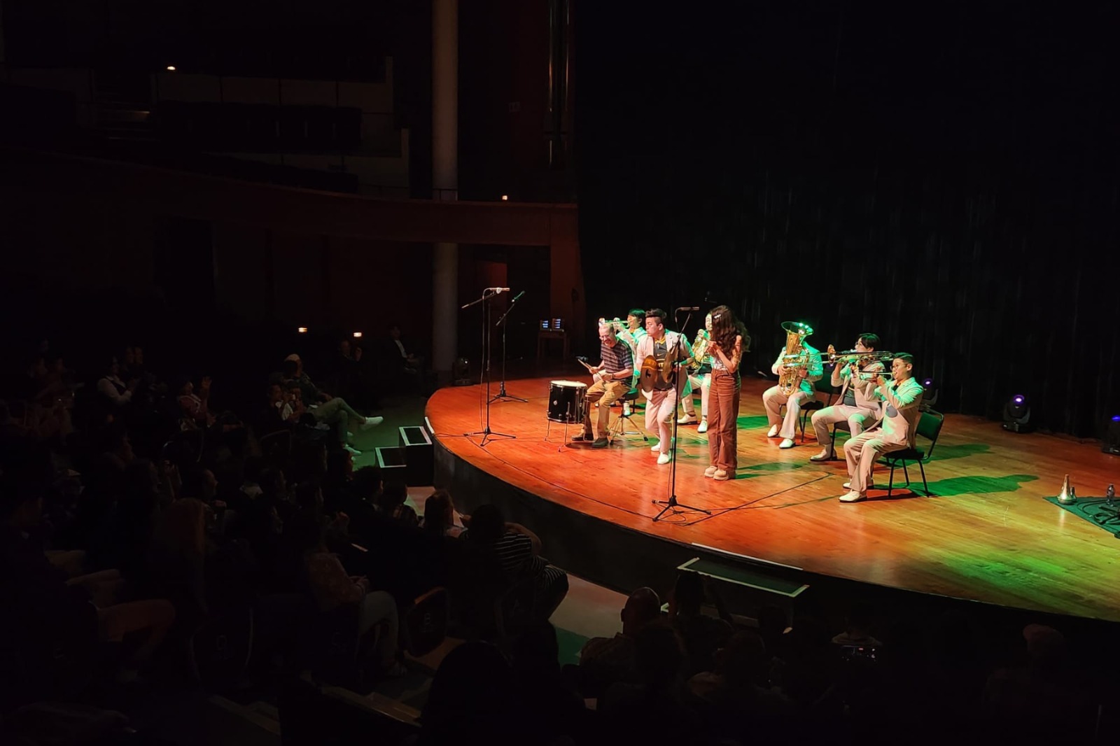 A group of people on a stage
Description automatically generated