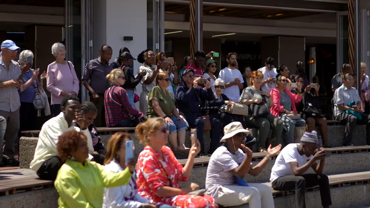 A group of people sitting on steps
Description automatically generated