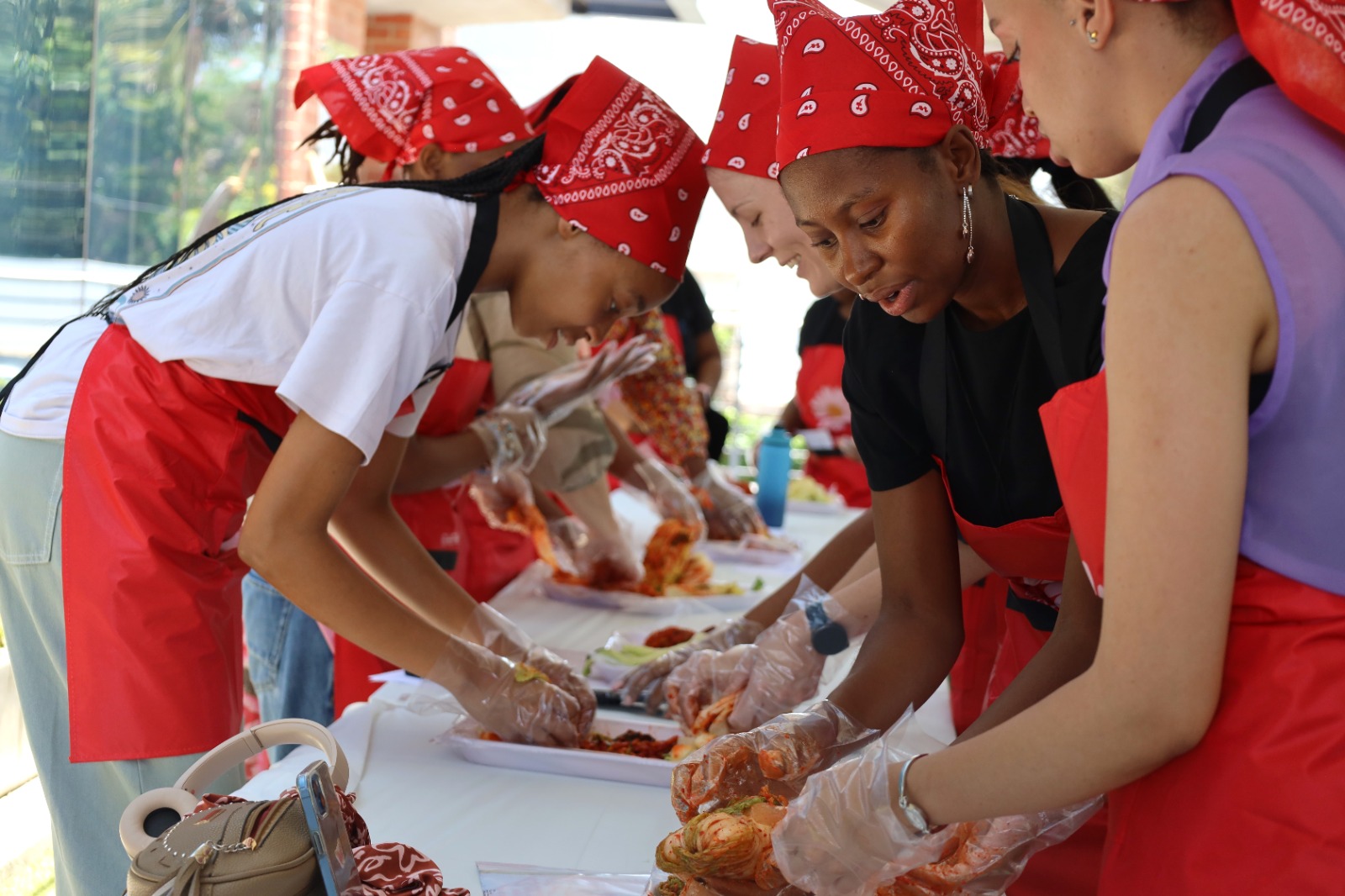 A group of people preparing food

Description automatically generated