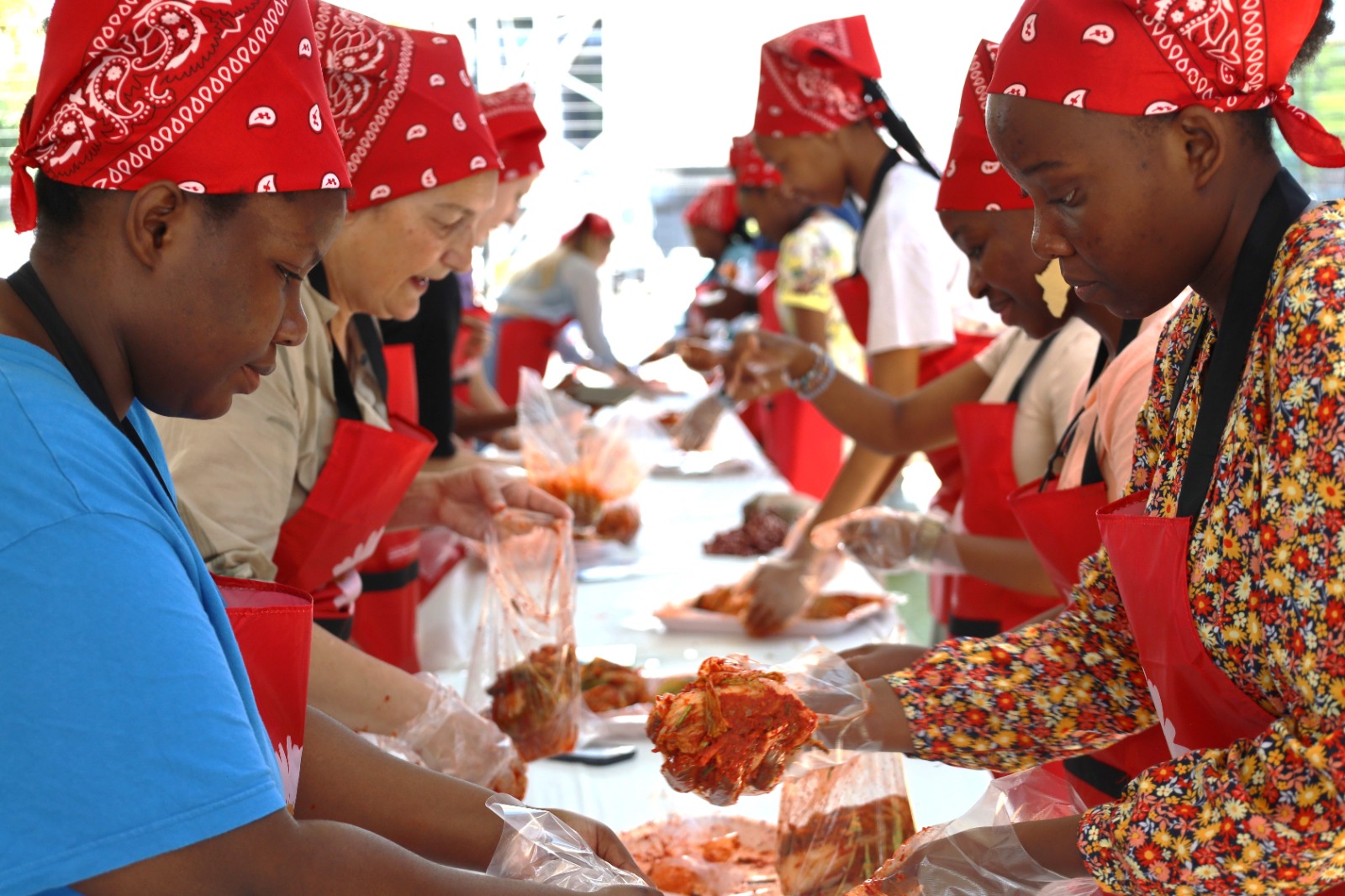 A group of people wearing red bandanas

Description automatically generated