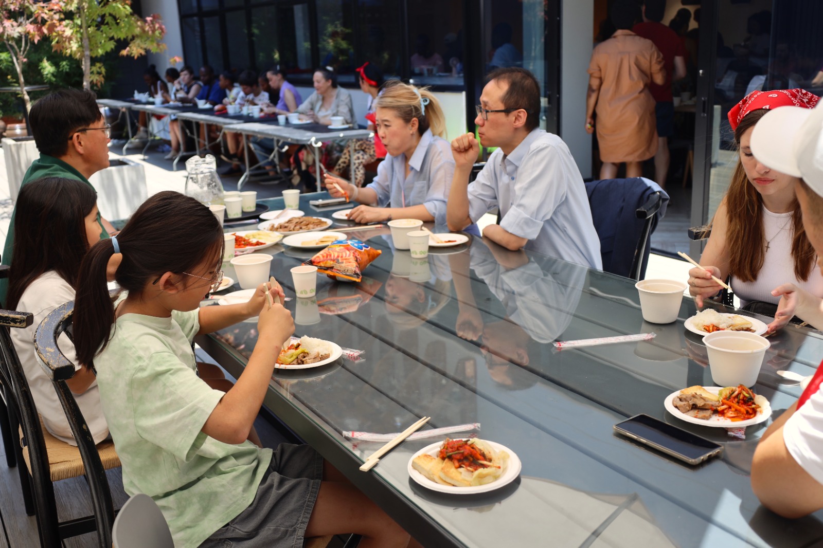 A group of people eating at a table

Description automatically generated