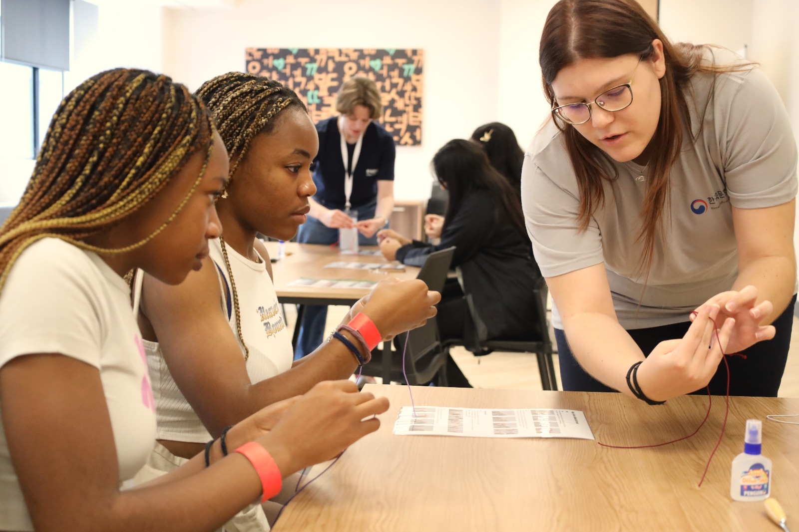 A group of women looking at papers

Description automatically generated