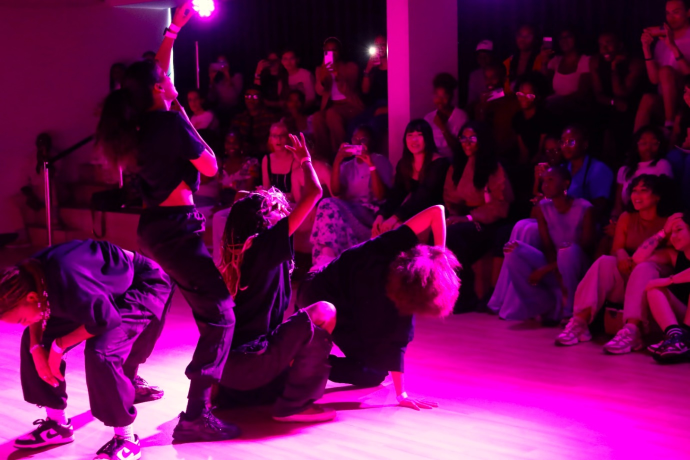 A group of people performing on a stage

Description automatically generated