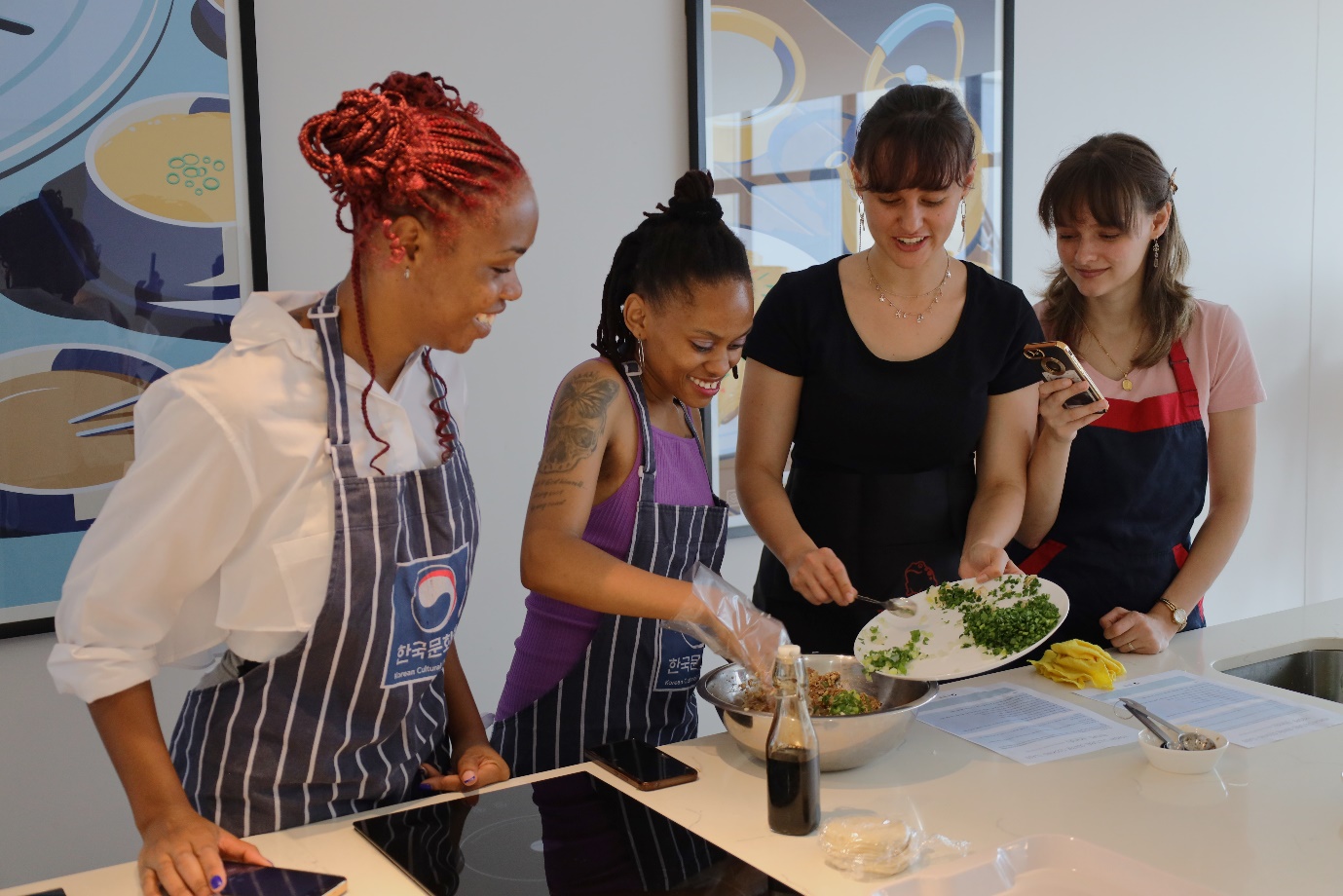 A group of women cooking

Description automatically generated