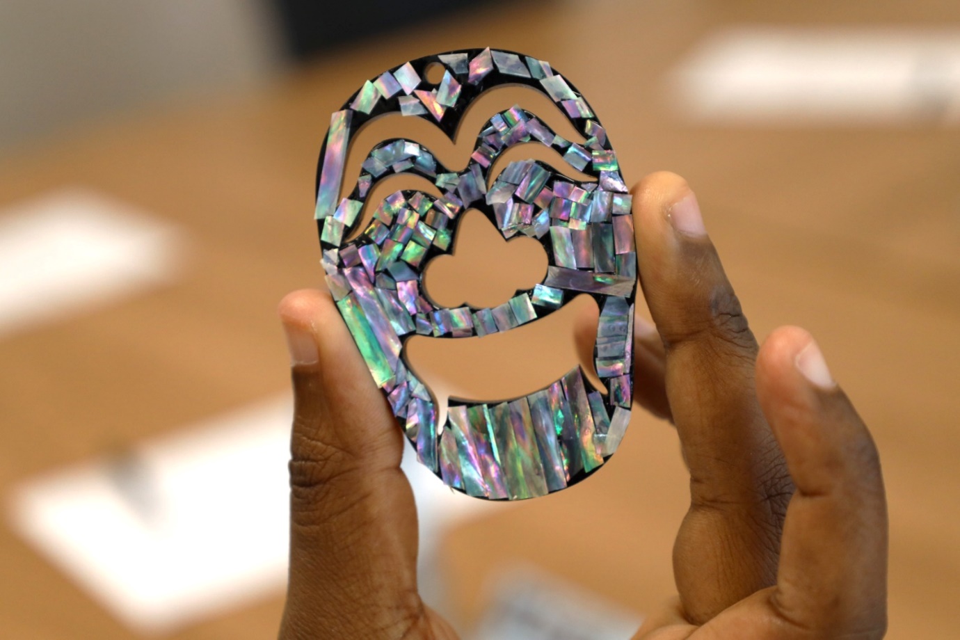 A person holding a piece of art

Description automatically generated
