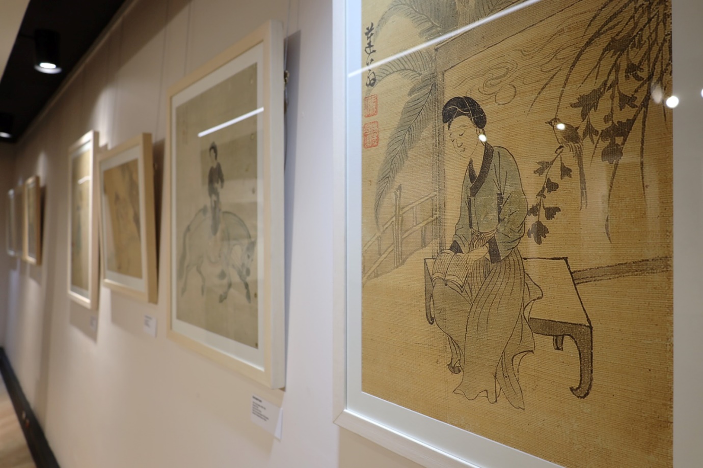 A wall with paintings on it

Description automatically generated