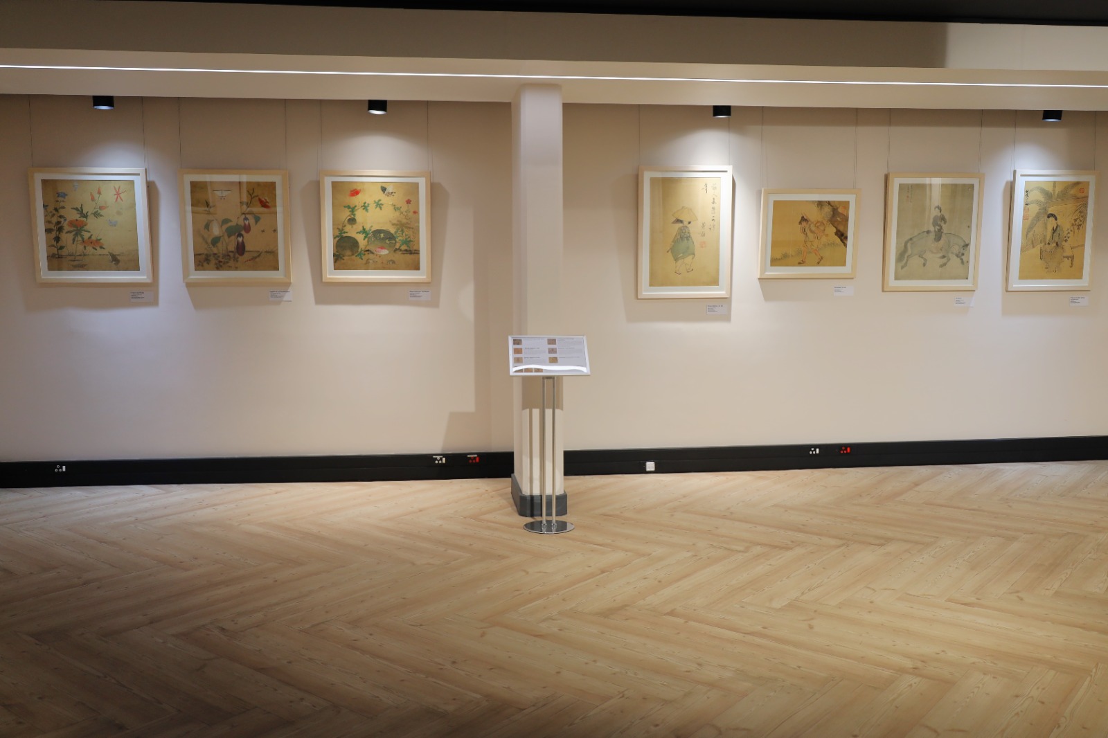 A room with paintings on the wall

Description automatically generated