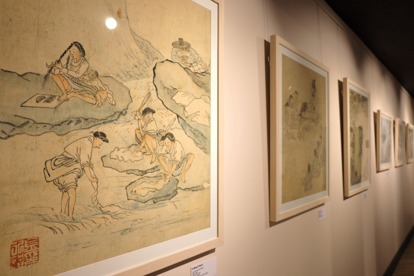 A group of paintings on a wall

Description automatically generated