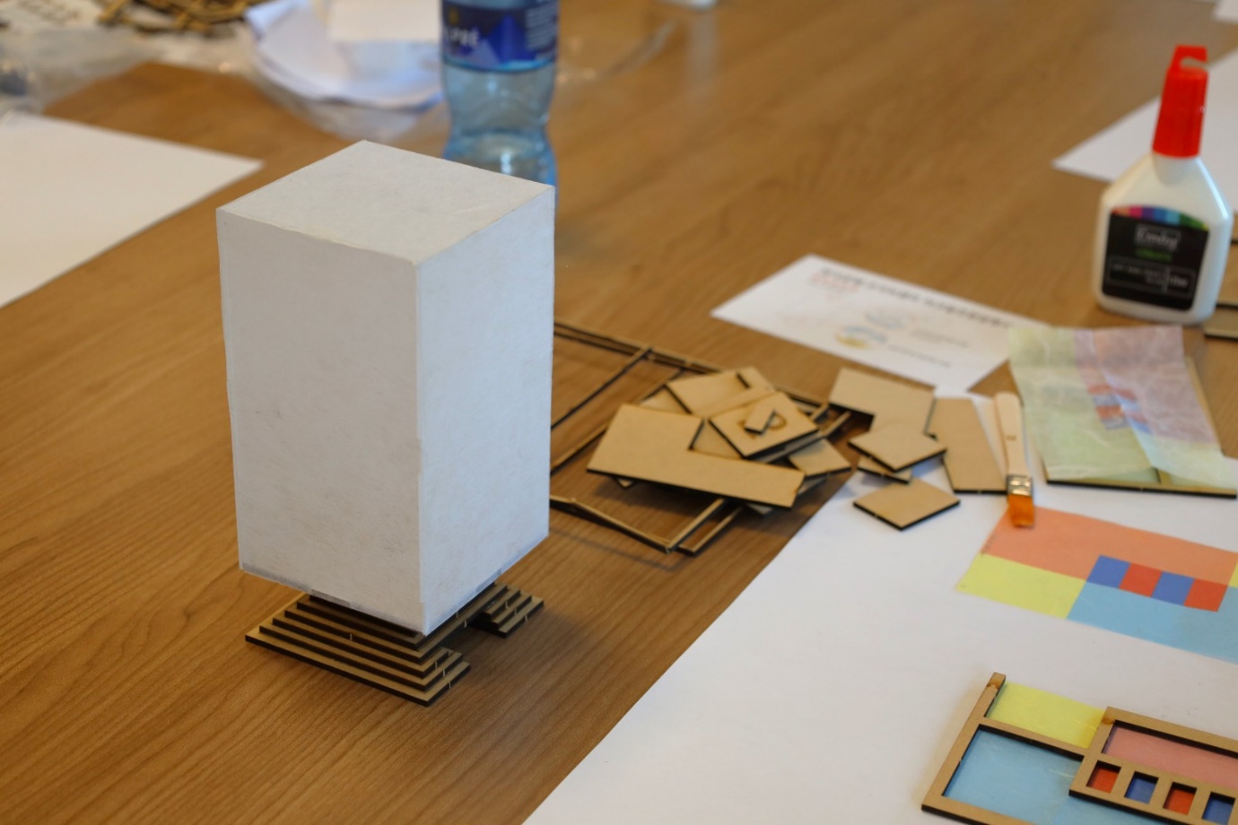 A white rectangular object on a table

Description automatically generated