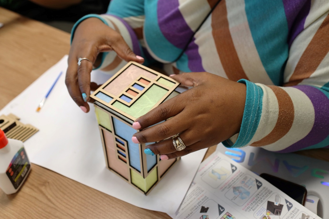 A person holding a small house

Description automatically generated