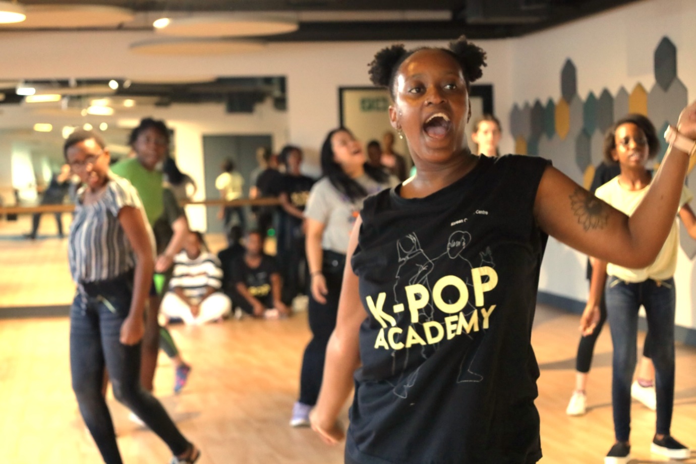 A group of people dancing in a room

Description automatically generated