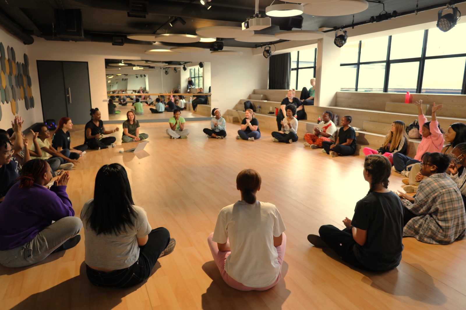 A group of people sitting in a circle

Description automatically generated