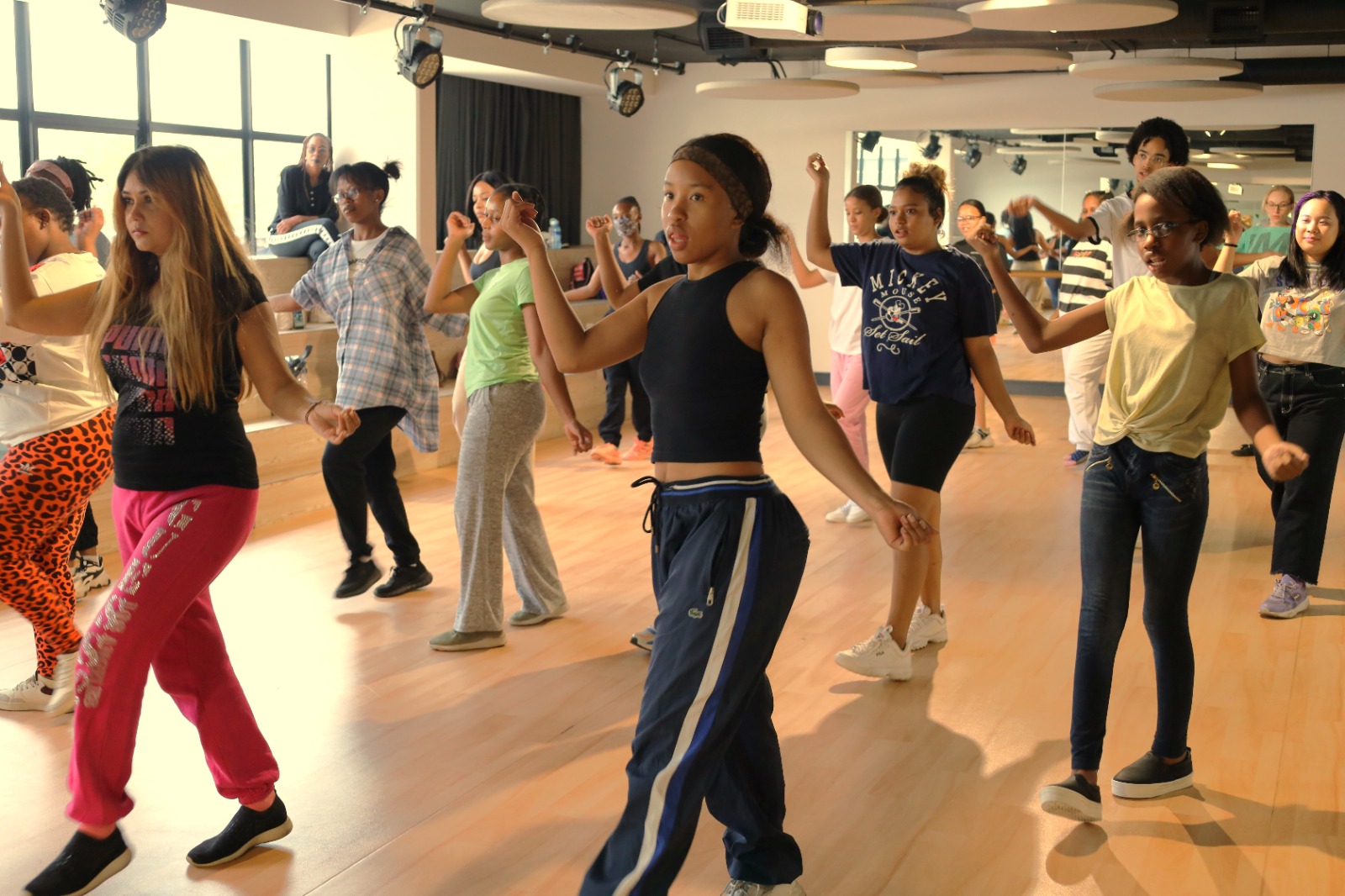 A group of people dancing in a room

Description automatically generated