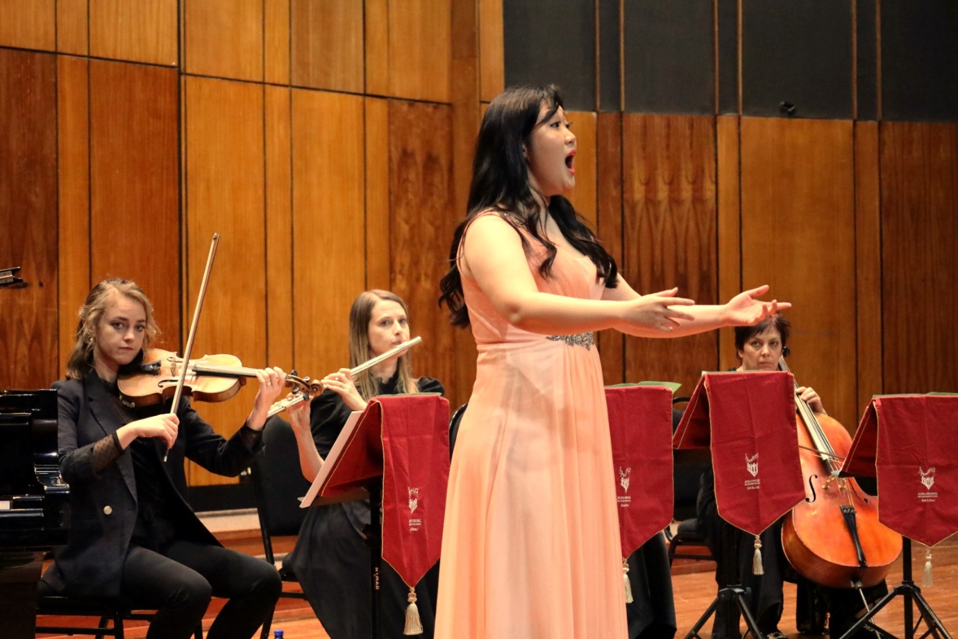 A group of people playing instruments

Description automatically generated
