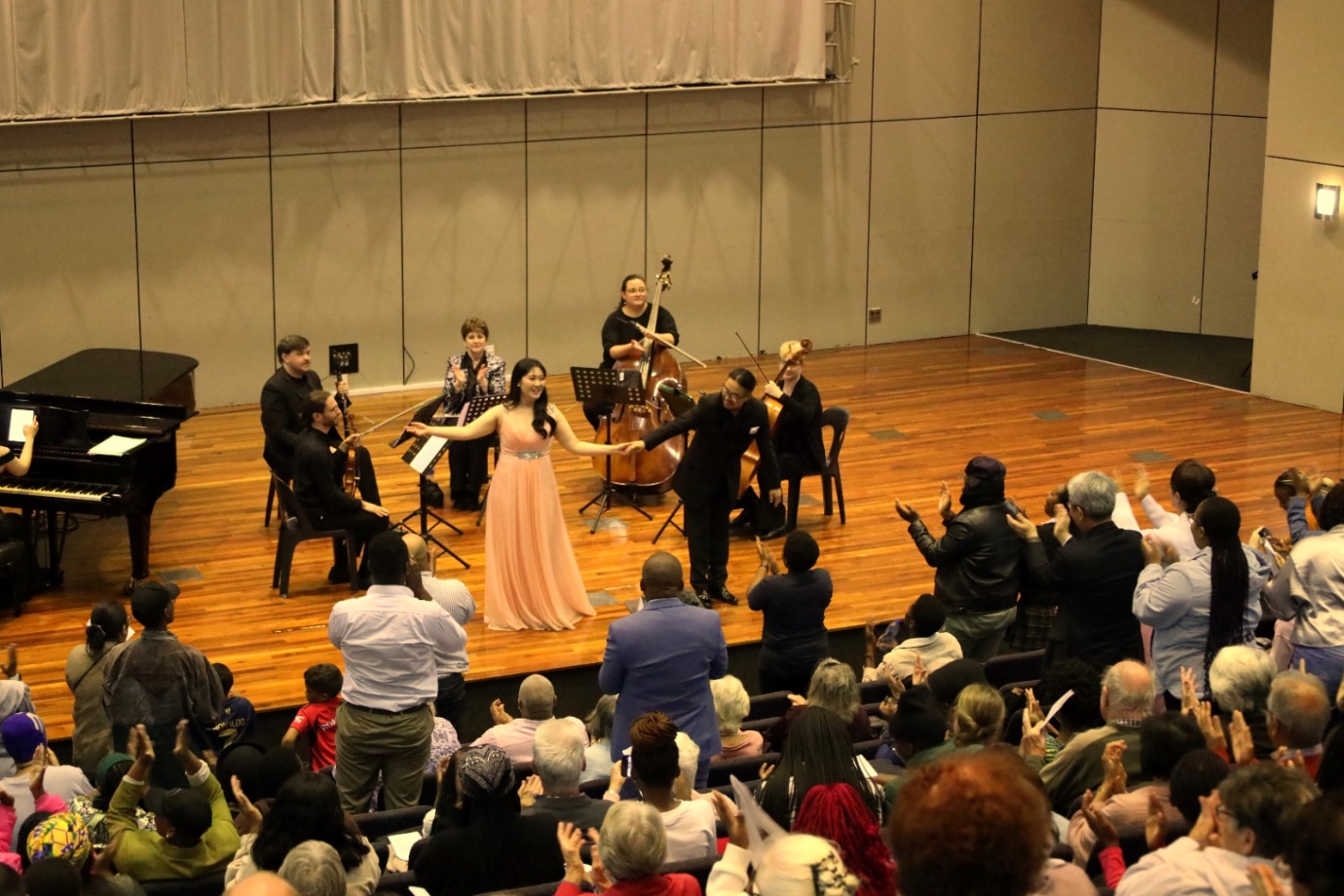 A group of people on a stage

Description automatically generated