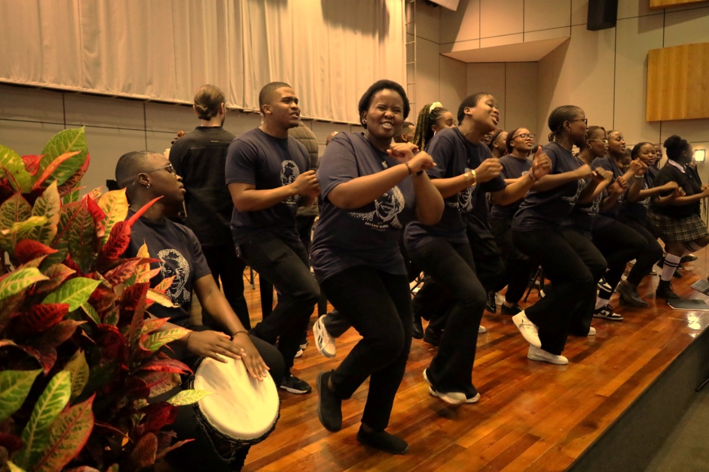 A group of people performing a dance

Description automatically generated