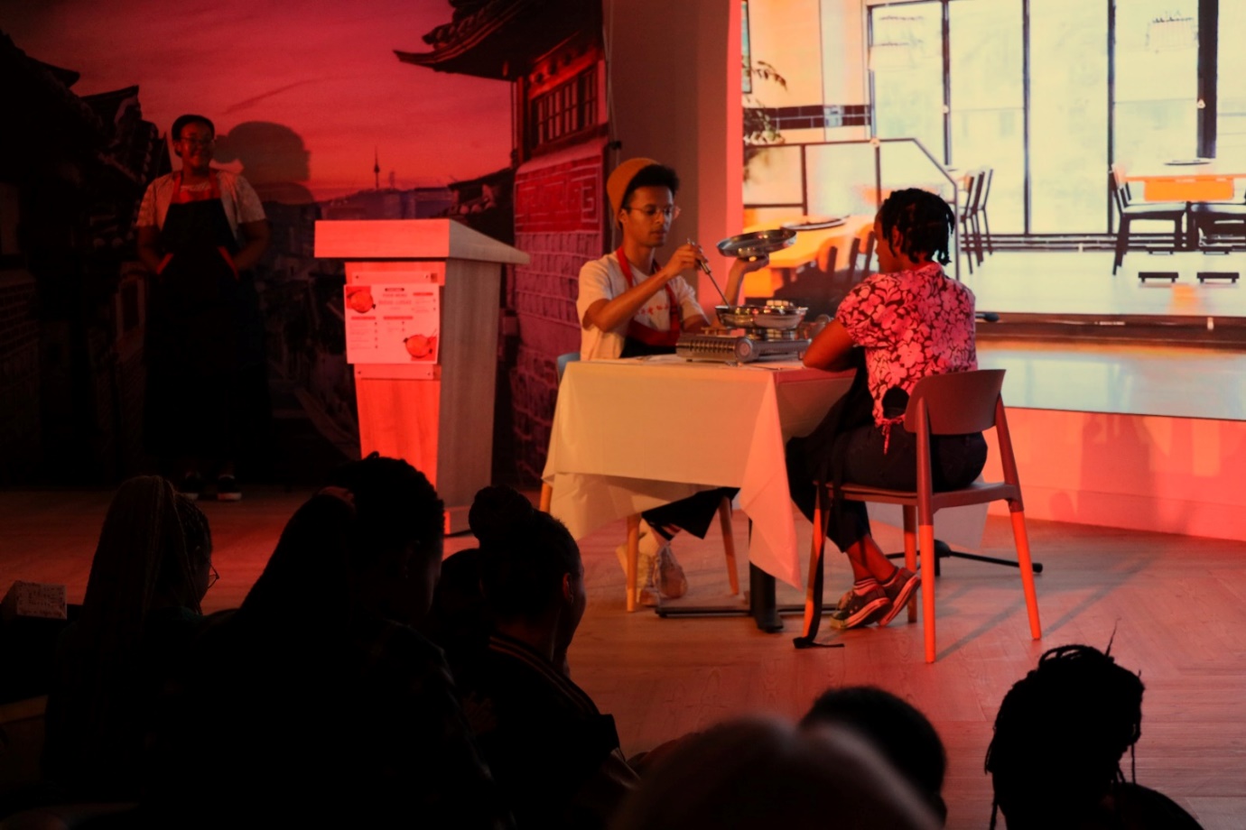 A person sitting at a table with a tray of food

Description automatically generated