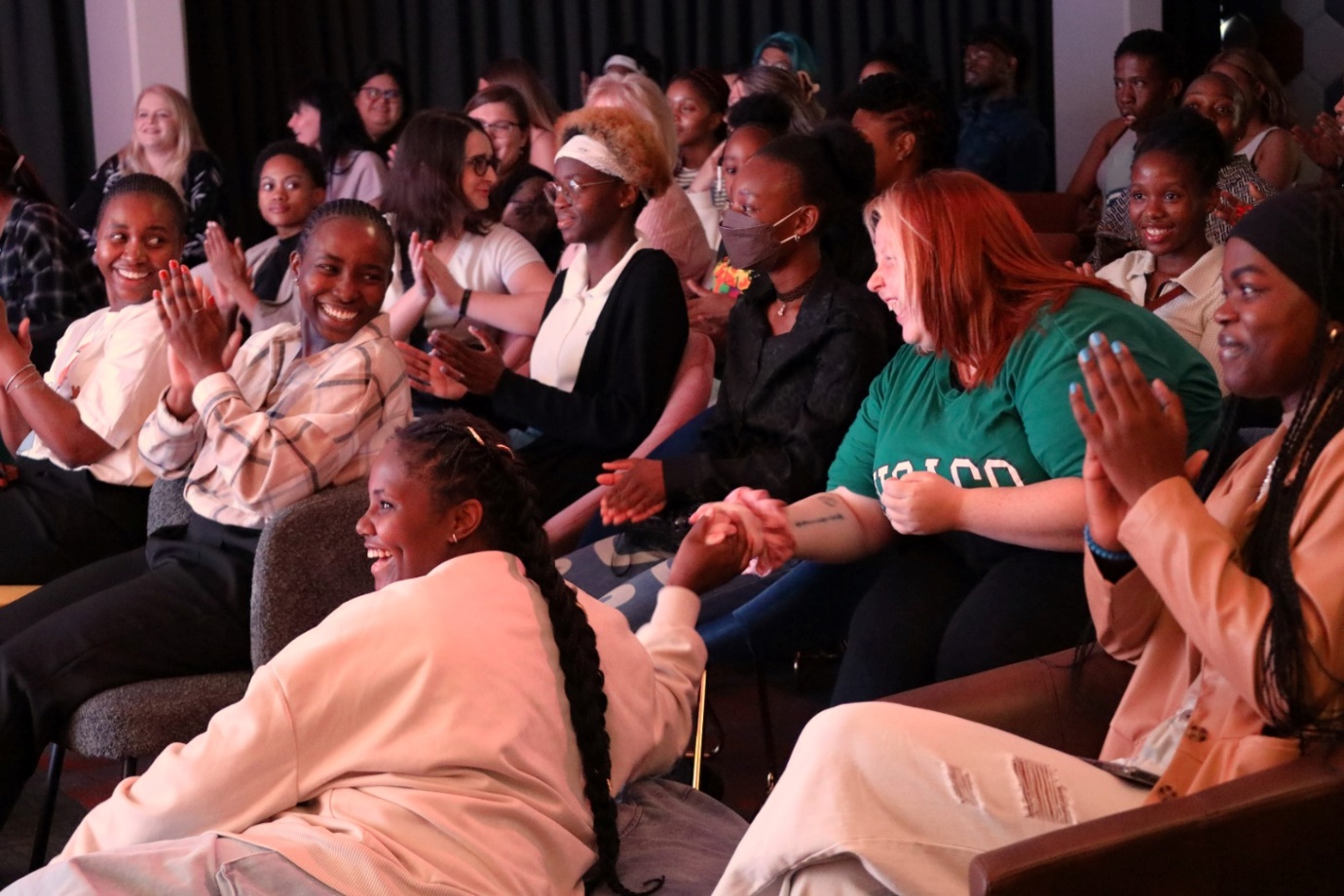 A group of people clapping

Description automatically generated