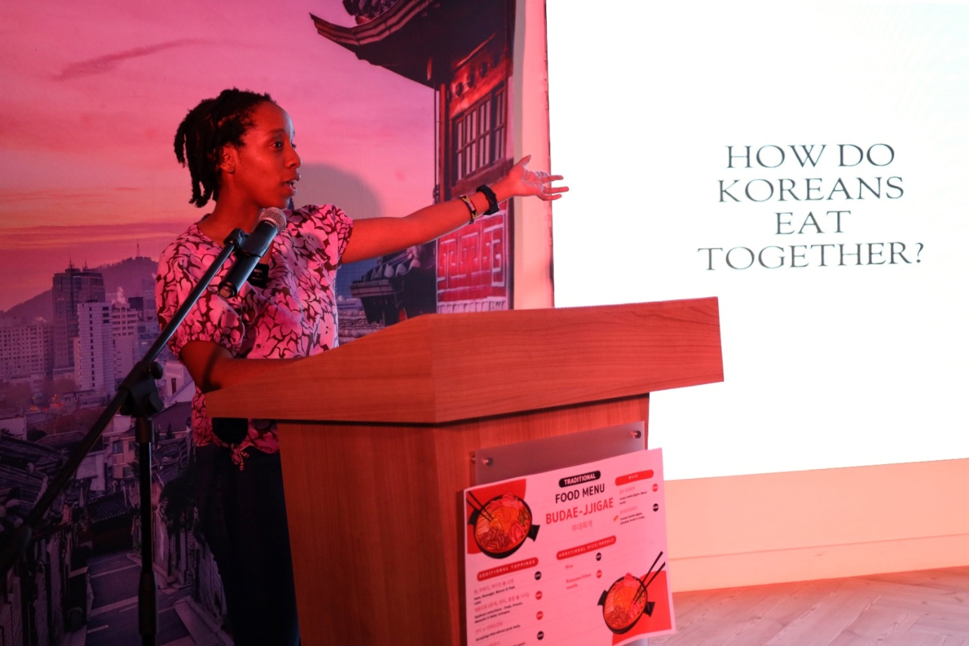 A person standing at a podium

Description automatically generated