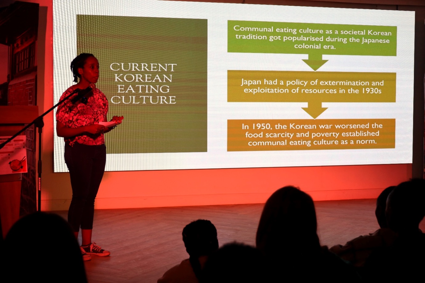 A person standing on a stage

Description automatically generated
