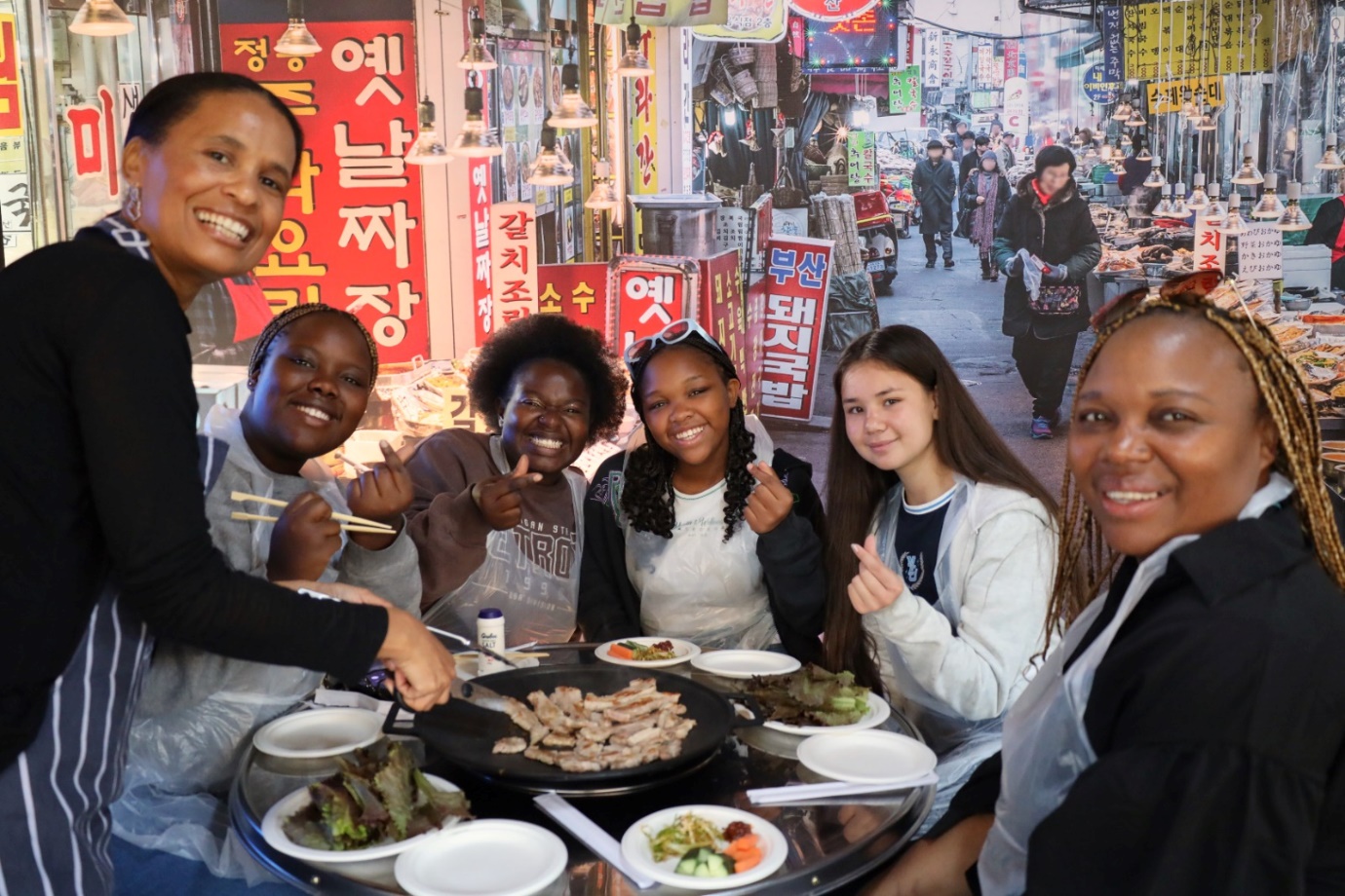 A group of people around a table with food

Description automatically generated