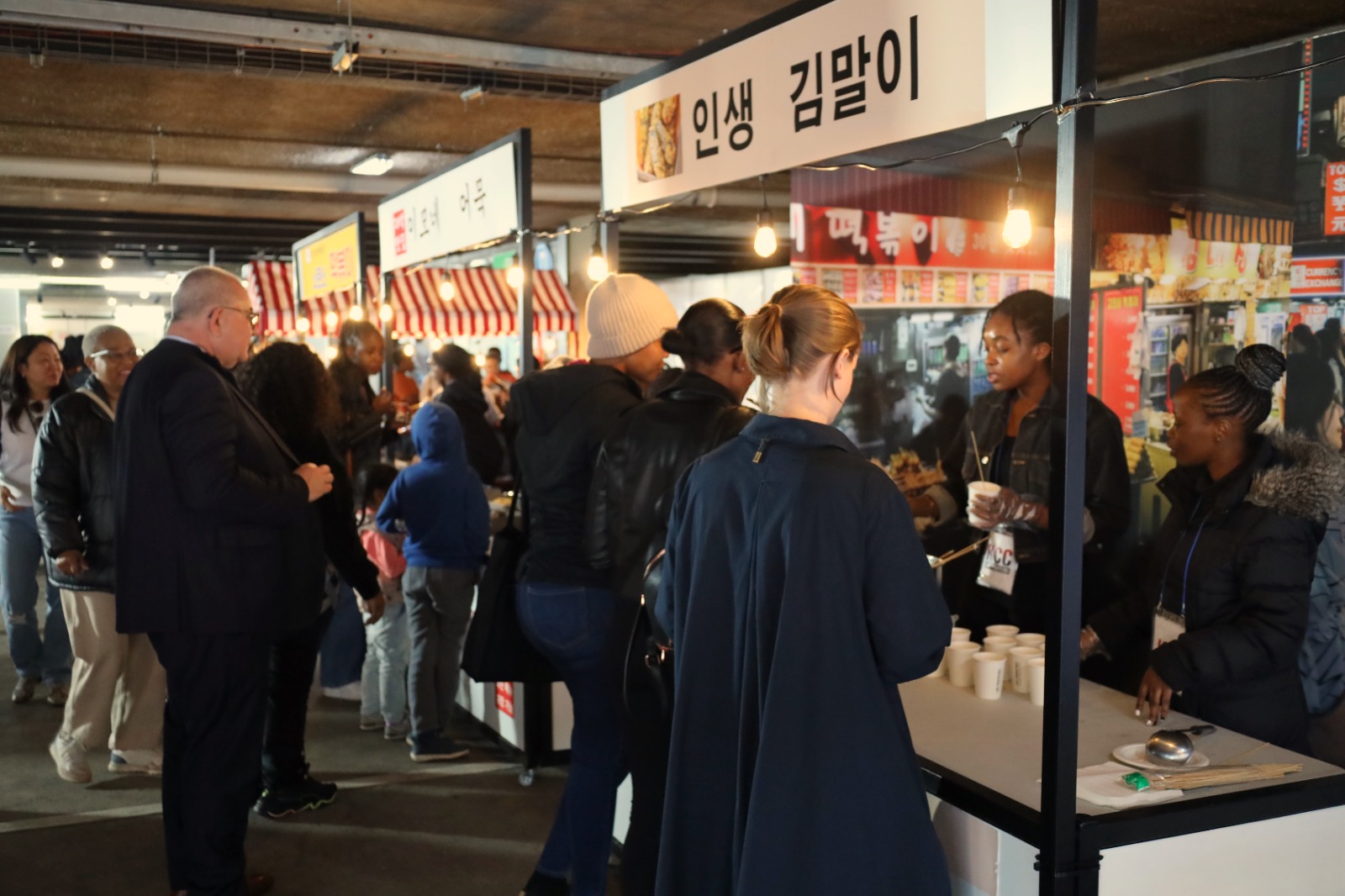 A group of people standing in a line

Description automatically generated