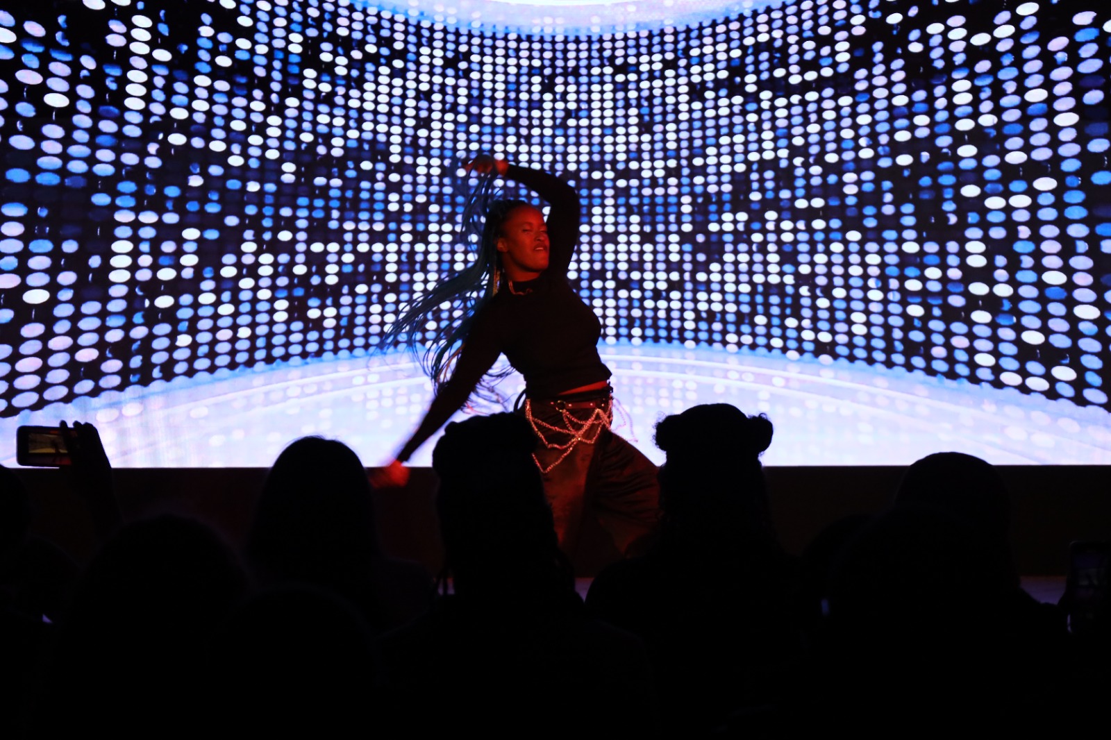A person dancing on a stage

Description automatically generated