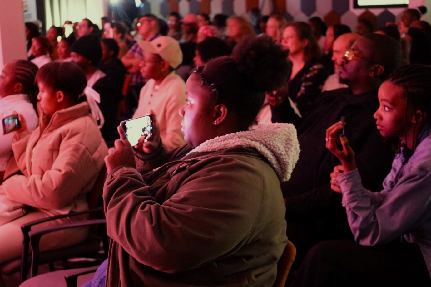 A person taking a picture of a crowd

Description automatically generated