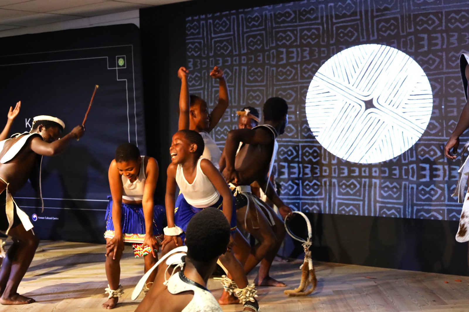 A group of people dancing on a stage

Description automatically generated