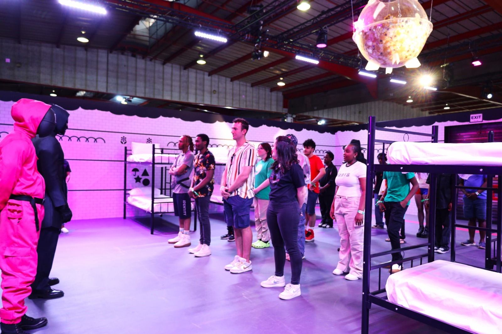 A group of people standing in a room

Description automatically generated