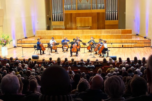 A group of people playing instruments

Description automatically generated