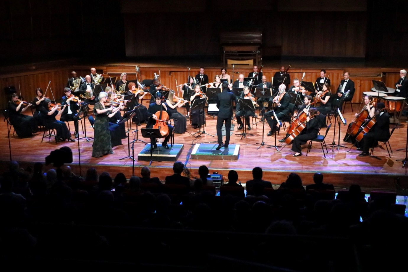 A group of people performing on stage

Description automatically generated