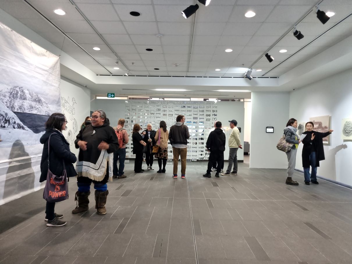 Guests and the artists are in conversation at the vernissage of the <Home and other places, Ottawa> exhibition.
