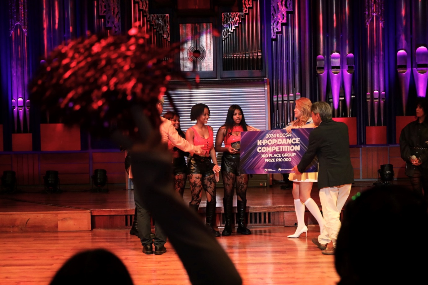A group of people on a stage

Description automatically generated