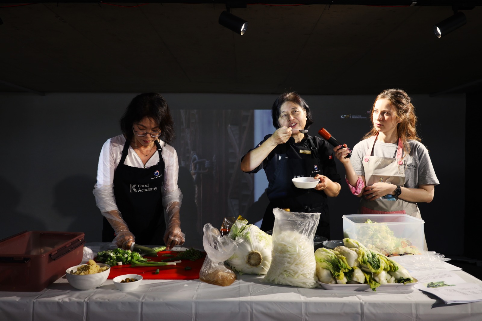 A group of women cooking

Description automatically generated