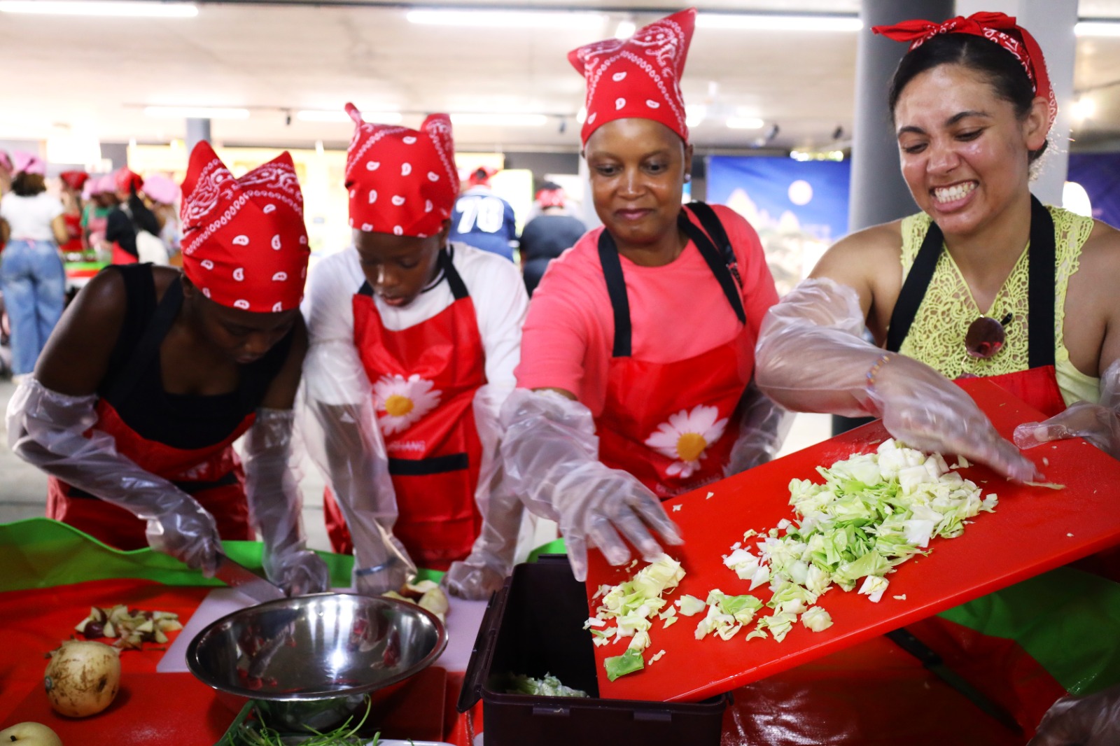 A group of women preparing food

Description automatically generated