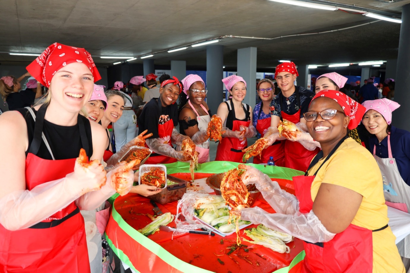 A group of women in aprons and bandanas

Description automatically generated