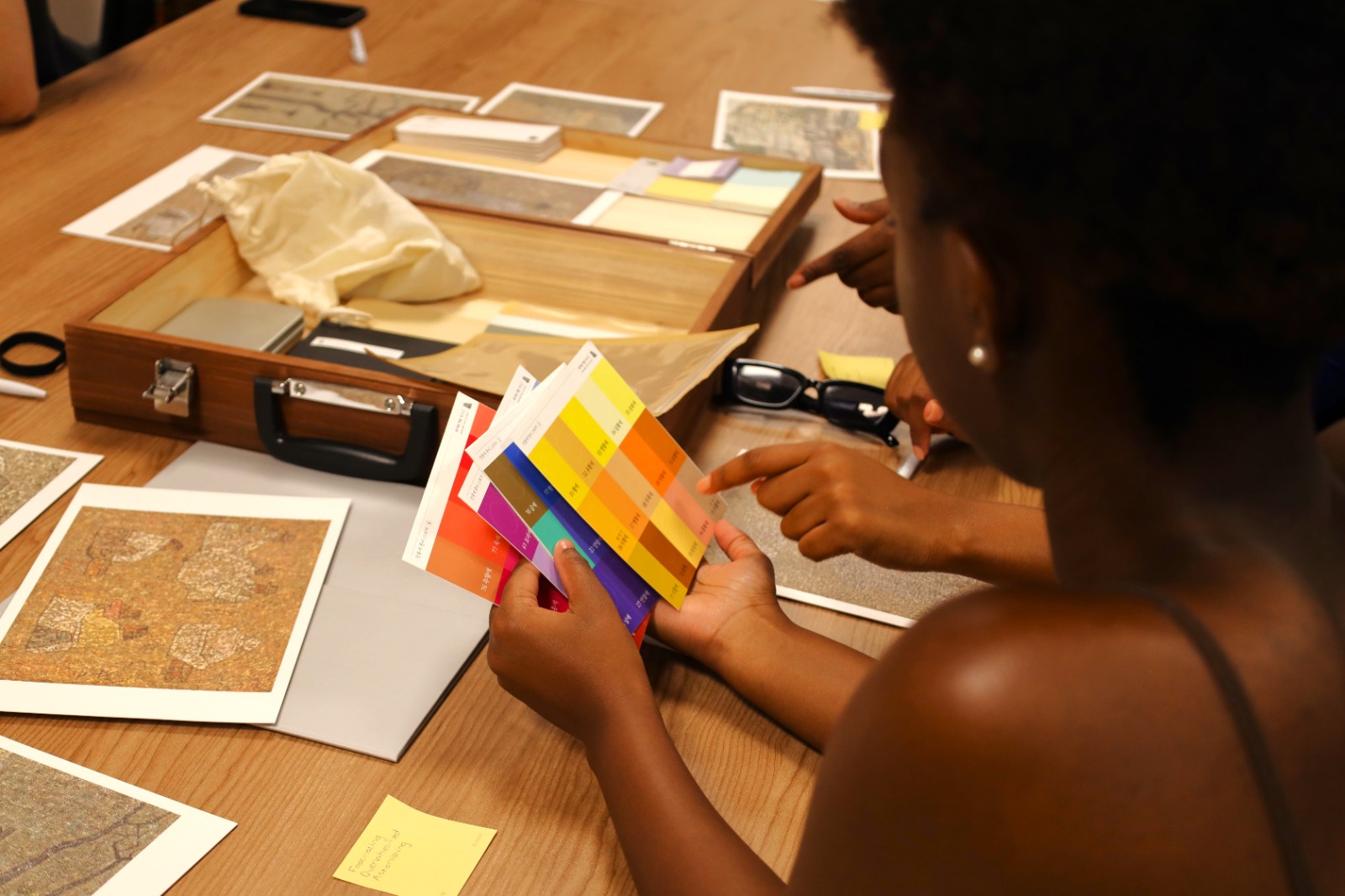 A person pointing at a color swatch
Description automatically generated