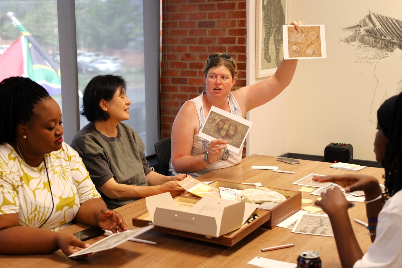 A group of people sitting around a table
Description automatically generated