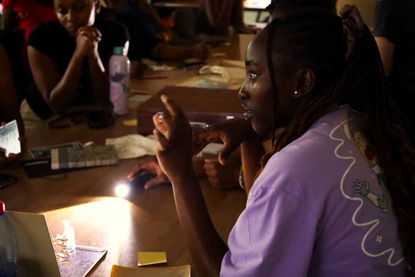 A group of people sitting at a table
Description automatically generated