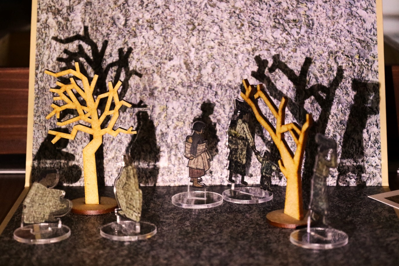 Several wooden figurines on a table
Description automatically generated