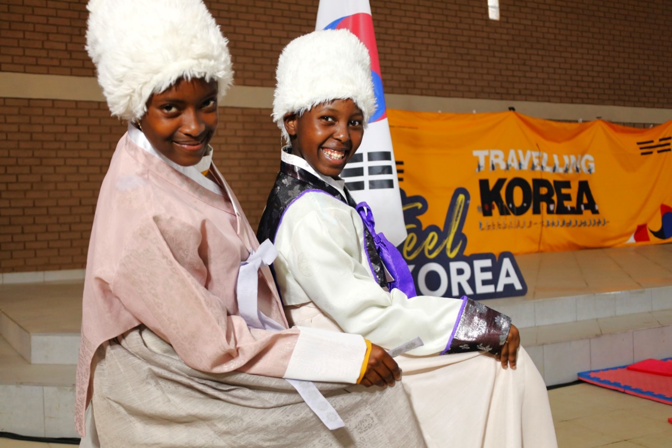 A couple of young women wearing white fur hats

Description automatically generated