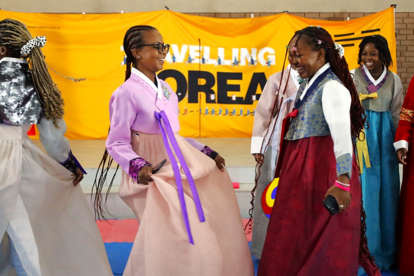 A group of women in traditional dress

Description automatically generated