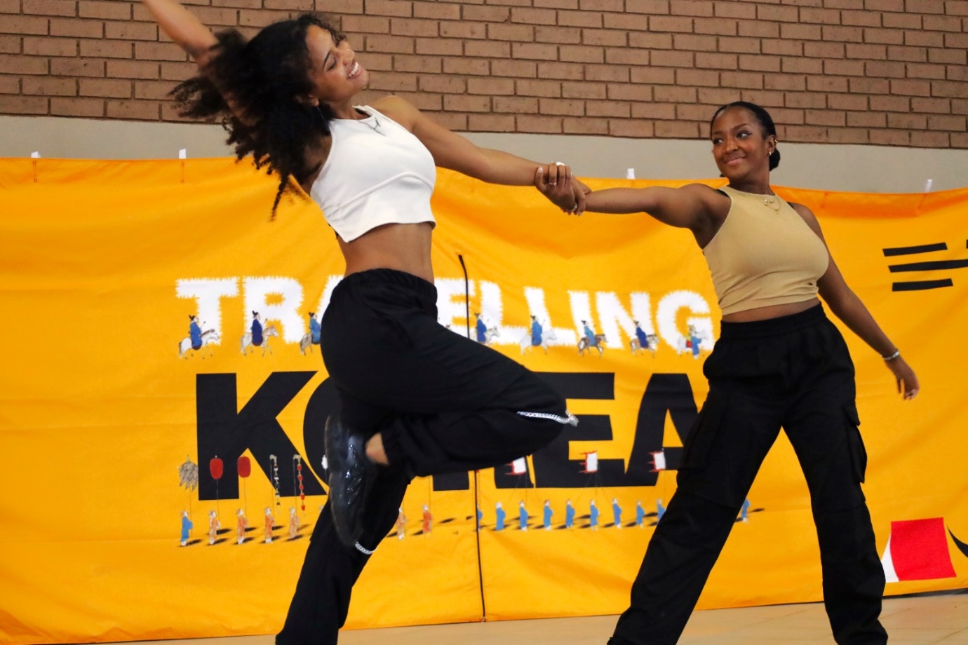 A couple of women dancing

Description automatically generated