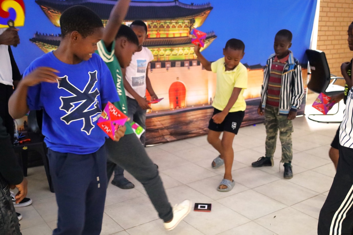 A group of boys playing a game

Description automatically generated
