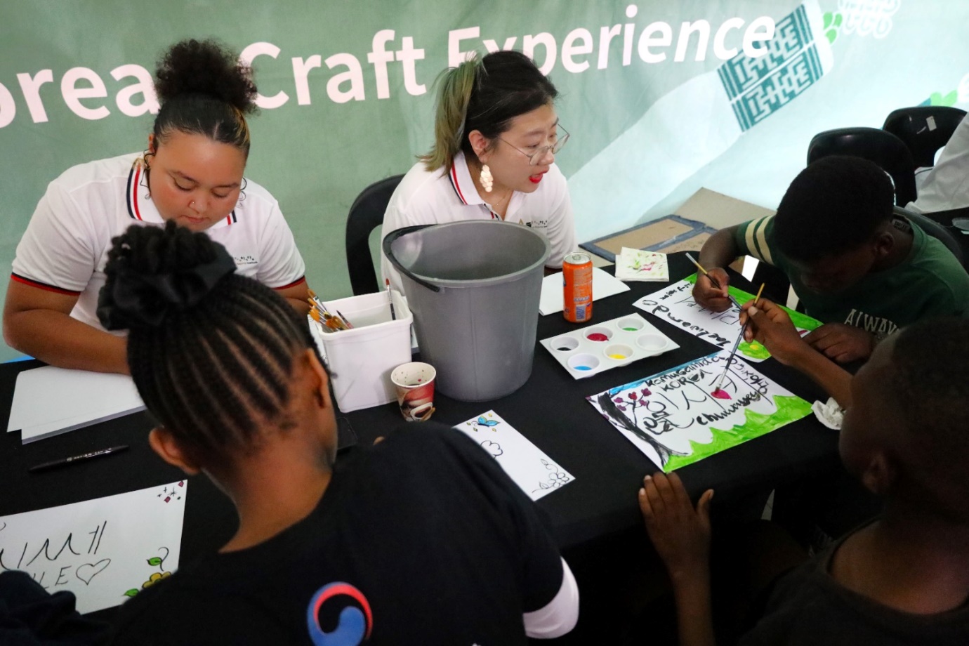 A group of people sitting around a table

Description automatically generated