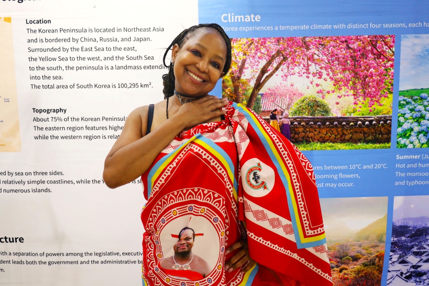 A person holding a red blanket

Description automatically generated