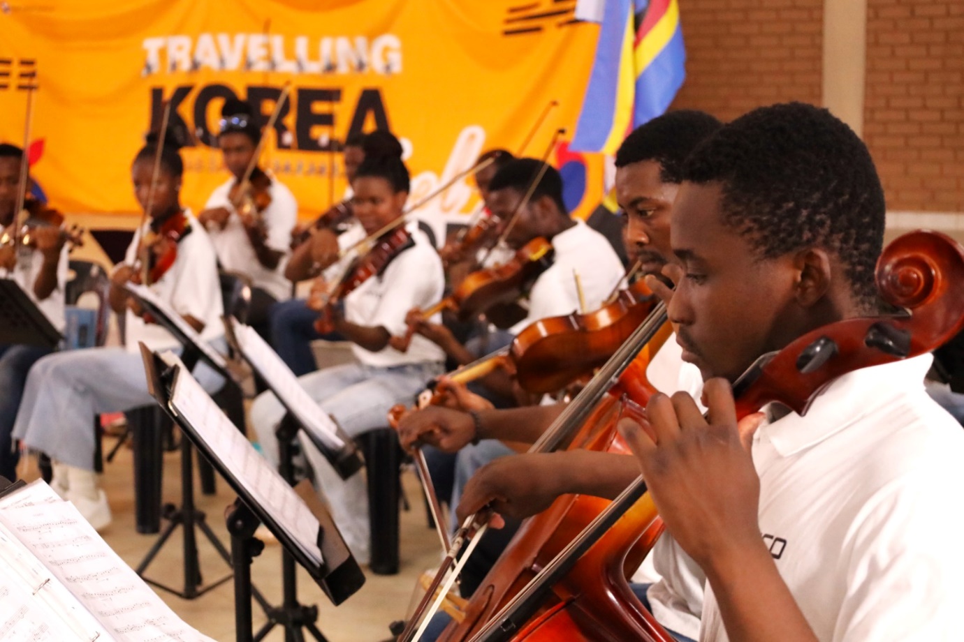 A group of people playing instruments

Description automatically generated