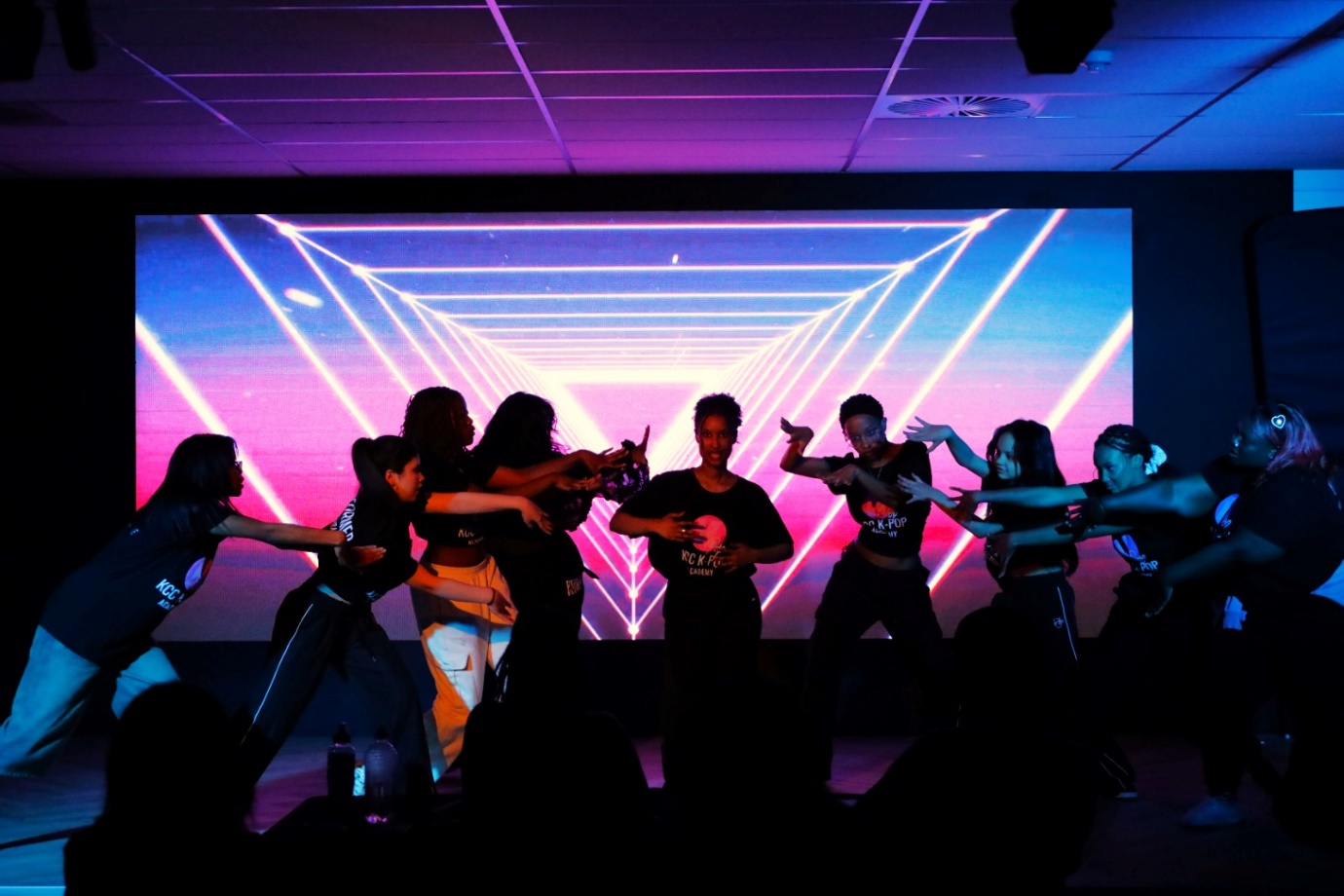 A group of people on a stage
Description automatically generated