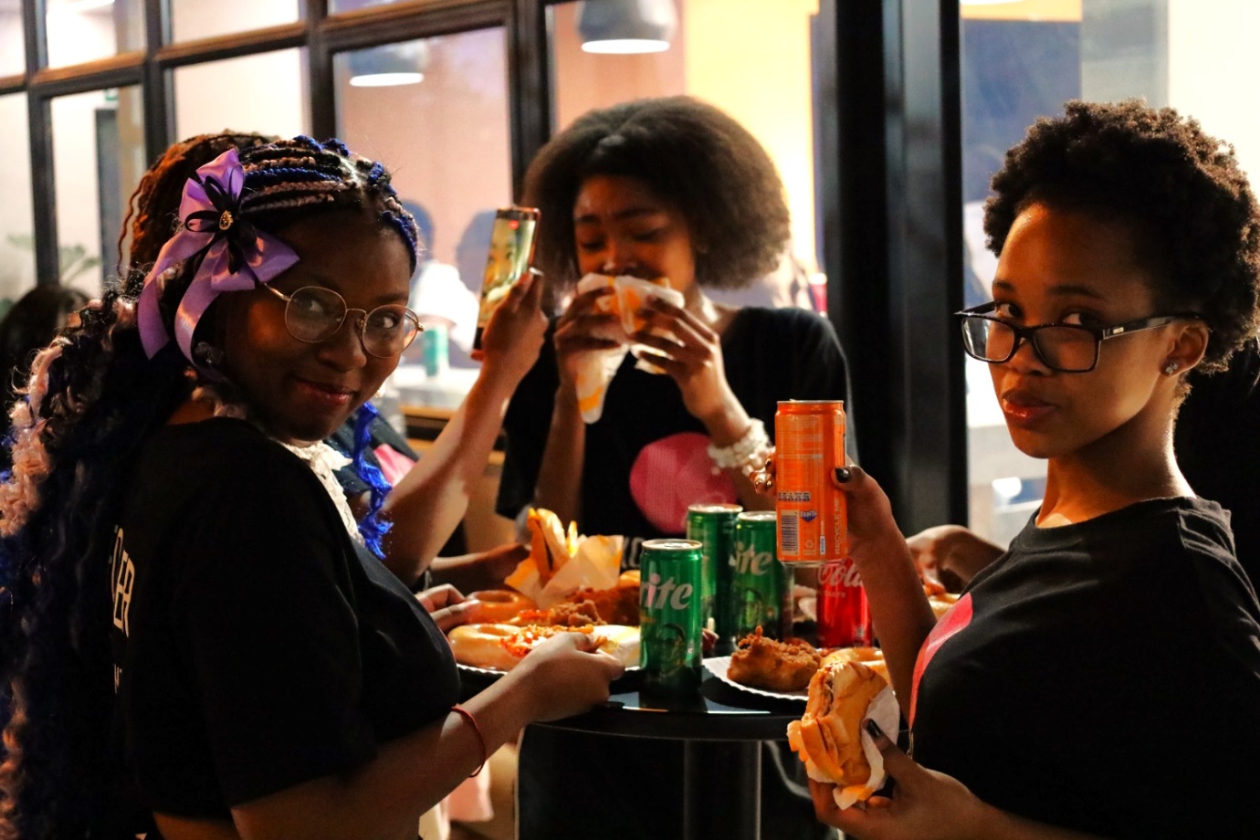 A group of women eating food
Description automatically generated